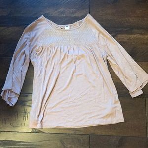 A cream color mid length sleeve shirt